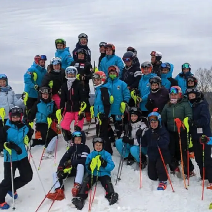 Skiers on a snowy slope at Bousquet Mountain
