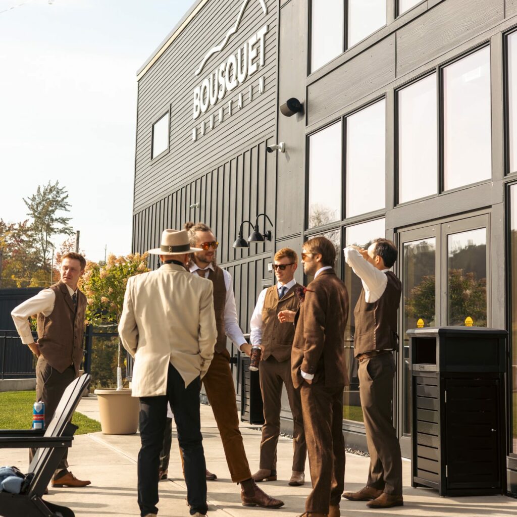 Wedding party standing outside the Bousquet Mountain lodge
